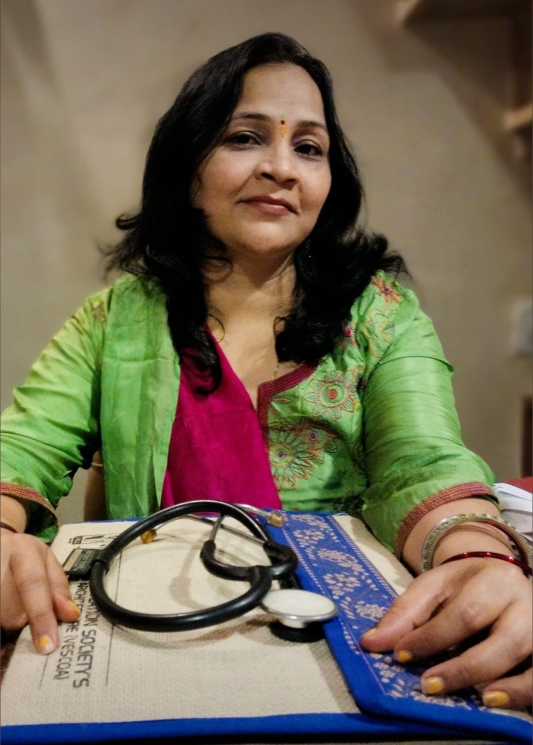 Dr. Megha Naik at her consultation desk with her stethoscope