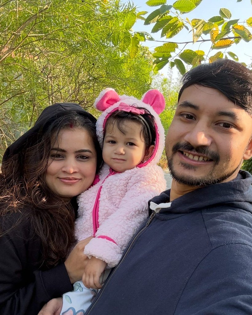 Rohit, Neha and their daughter Devi in the garden
