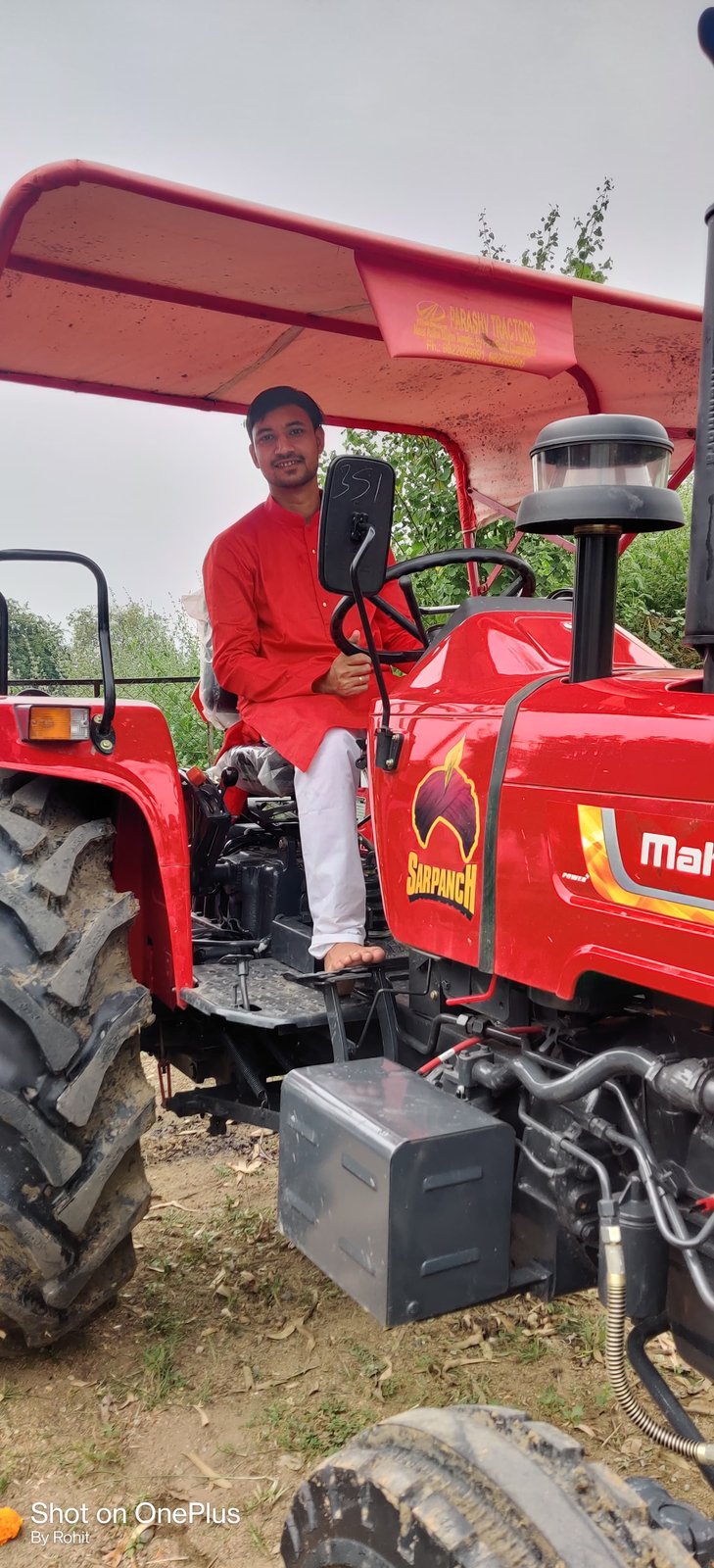 Rohit on the family's Mahindra tractor